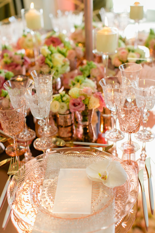 A gorgeous blush wedding table set up with a white orchid placed on top